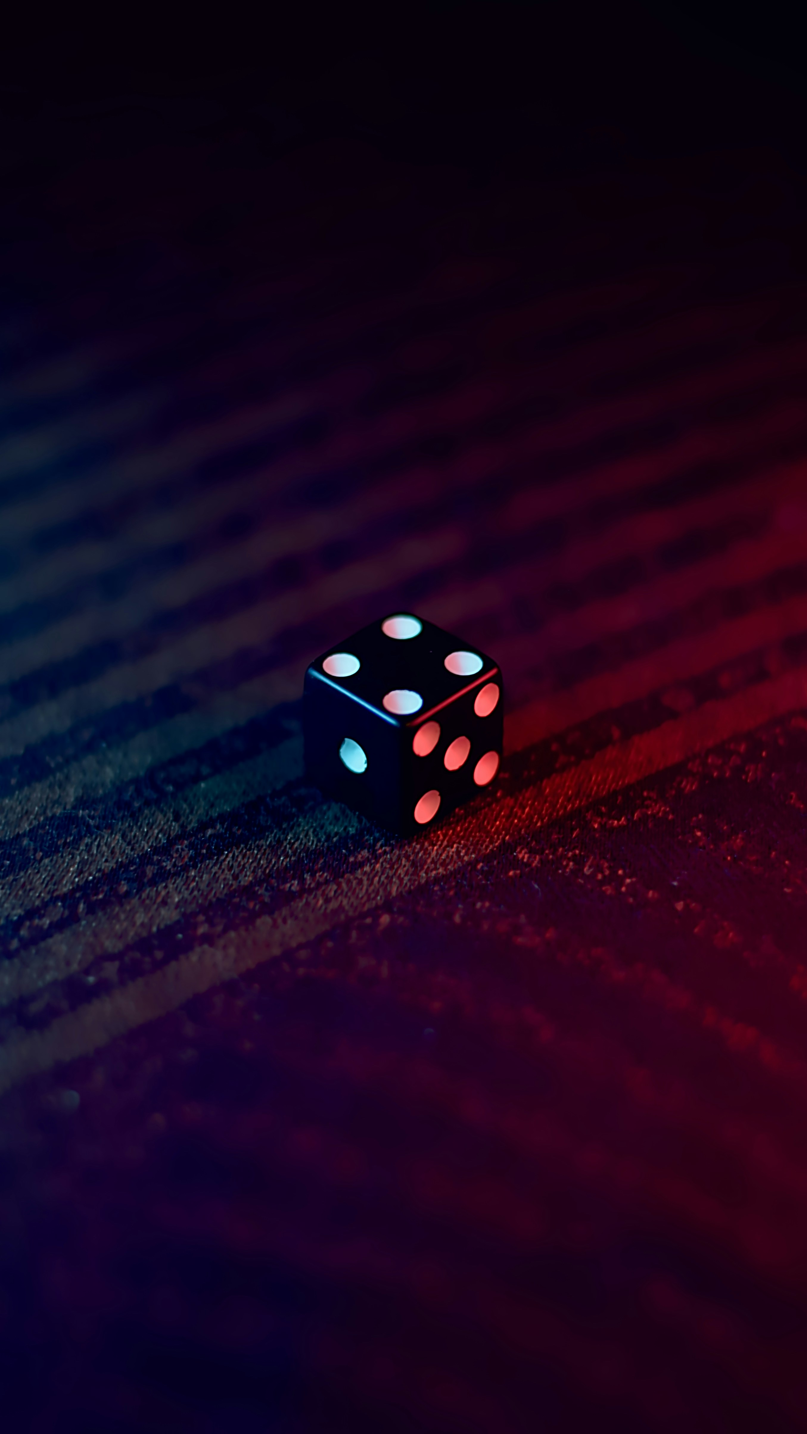 Cover — black die with dramatic lighting